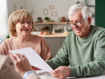 Senior couple signing a contract